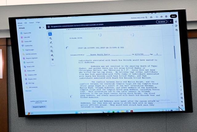A report from an 1999 FBI interview with Duane Davis is displayed during the Davis murder trial, related to the 1996 killing of rapper Tupac Shakur, at Clark County District Court at the Regional Justice Center in Las Vegas, Nevada, on August 19, 2026. The trial of the former gang leader accused of orchestrating the murder of rapper Tupac Shakur began on August 10, 30 years after one of America's most high-profile unresolved killings. The proceedings, expected to last a month, will likely not make clear who fired the shots that killed the California hip-hop legend on the night of September 7, 1996, while he was in Las Vegas to see a Mike Tyson boxing match. (Photo by David Becker / POOL / AFP)