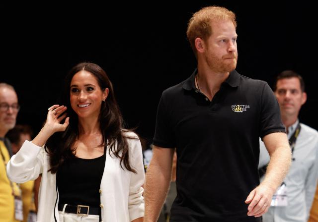 (FILES) Britain's Meghan, Duchess of Sussex and Britain's Prince Harry, Duke of Sussex, arrive at the 2023 Invictus Games in Duesseldorf, western Germany on September 13, 2023. Prince Harry and his wife Meghan, who cut ties with the British royal family in 2020, are moving back to the United Kingdom, British press reported on August 19, 2026. (Photo by Odd ANDERSEN / AFP)
