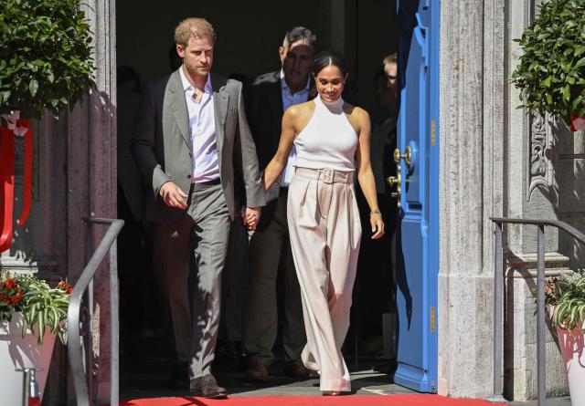 (FILES) Meghan, Duchess of Sussex and Prince Harry, Duke of Sussex  leave the city hall in Duesseldorf, western Germany, on September 6, 2022 after attending a reception in the context of the "One Year to Go" event of the Invictus Games Duesseldorf 2023. Prince Harry and his wife Meghan, who cut ties with the British royal family in 2020, are moving back to the United Kingdom, British press reported on August 19, 2026. (Photo by Sascha Schuermann / AFP)
