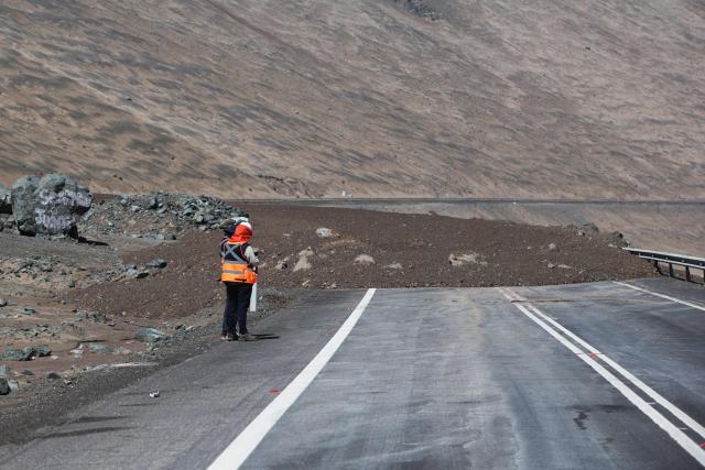 A highway covered with mud and debris is pictured after a landslide struck the city of Iquique, due to heavy rainfall in the north of Chile on August 19, 2026. (Photo by Alex DIAZ / AFP)