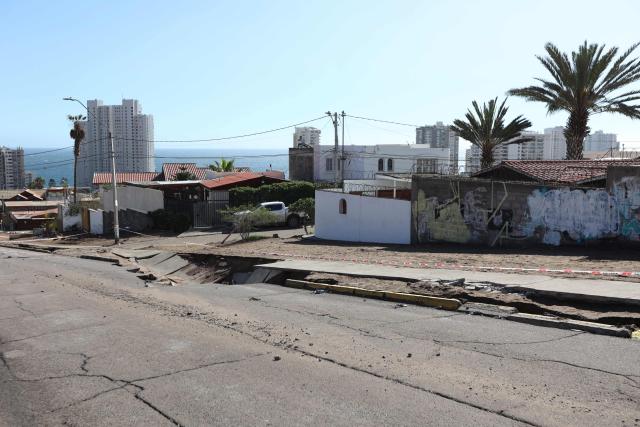 A damaged street is pictured due to heavy rainfall in Iquique, Chile on August 19, 2026. (Photo by Alex DIAZ / AFP)