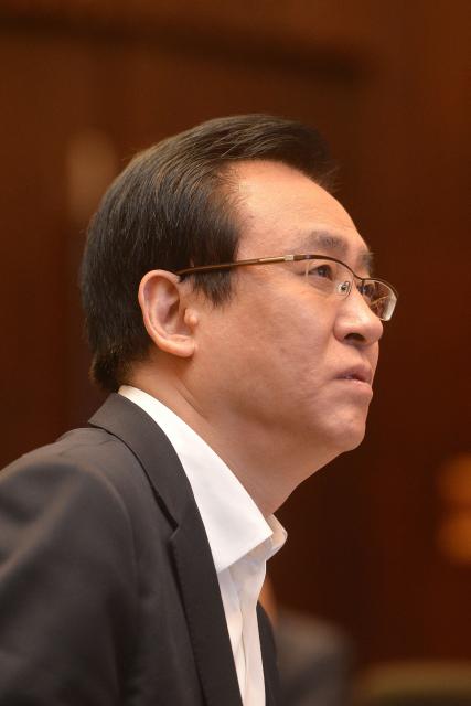 (FILES) This photo taken on June 5, 2017 shows Evergrande's president Xu Jiayin, also known as Hui Ka Yan in Cantonese, attending a meeting in Wuhan, in China's central Hubei province. A Chinese court on August 20, 2026 fined embattled property giant Evergrande billions of yuan and sentenced its founder Xu Jiayin to life in prison. (Photo by CN-STR / AFP) / China OUT