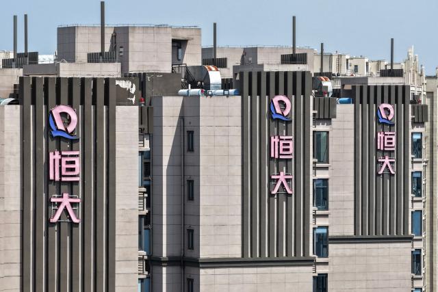 (FILES) Evergrande Group logos are seen on apartment buildings in Nanjing, China's eastern Jiangsu province on August 25, 2025. A Chinese court on August 20, 2026 fined embattled property giant Evergrande billions of yuan and sentenced its founder Xu Jiayin to life in prison. (Photo by CN-STR / AFP) / China OUT