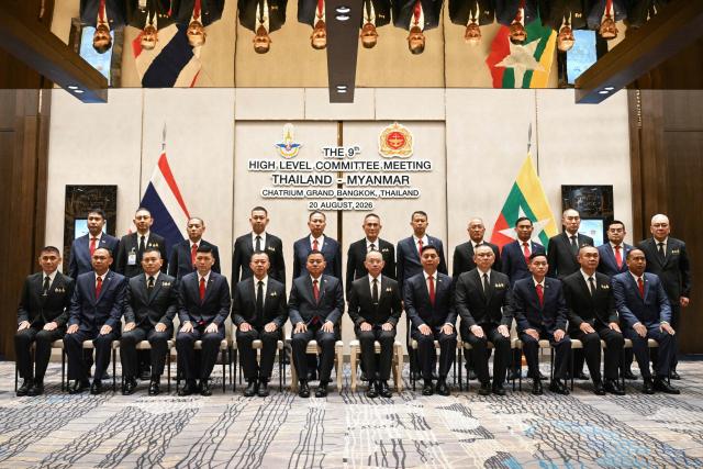 Myanmar’s military commander-in-chief, General Ye Win Oo (front centre L) and Thailand’s Chief of Defence Forces, Ukrit Boontanon (front centre R) pose for a group photo with their delegates after their High-Level Committee Meeting talks at the Chatrium Grand hotel in Bangkok on August 20, 2026. (Photo by ANTHONY WALLACE / AFP)