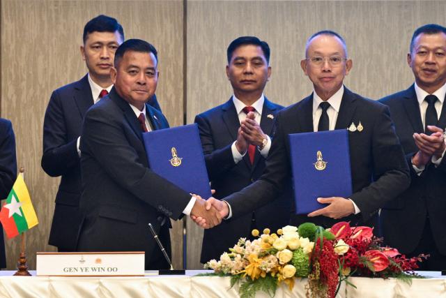 Myanmar’s military commander-in-chief, General Ye Win Oo (centre L) and Thailand’s Chief of Defence Forces, Ukrit Boontanon (centre R) shake hands after their High-Level Committee Meeting talks at the Chatrium Grand hotel in Bangkok on August 20, 2026. (Photo by ANTHONY WALLACE / AFP)