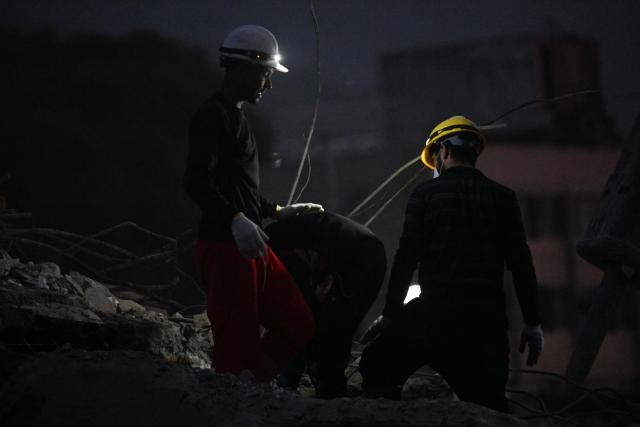 Rescue volunteers search through the rubble of collapsed buildings following the June 24 earthquakes along the coastal strip in Caraballeda, La Guaira state, Venezuela, on August 19, 2026. Nearly two months since the disaster, relatives and rescuers continue searching for the missing amid the rubble. The 7.2 and 7.5 magnitude quakes knocked down at least 190 buildings when they struck near Venezuela's coast on June 24. (Photo by Juan BARRETO / AFP)