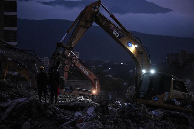 Rescue volunteers search through the rubble of collapsed buildings following the June 24 earthquakes along the coastal strip in Caraballeda, La Guaira state, Venezuela, on August 19, 2026. Nearly two months since the disaster, relatives and rescuers continue searching for the missing amid the rubble. The 7.2 and 7.5 magnitude quakes knocked down at least 190 buildings when they struck near Venezuela's coast on June 24. (Photo by Juan BARRETO / AFP)