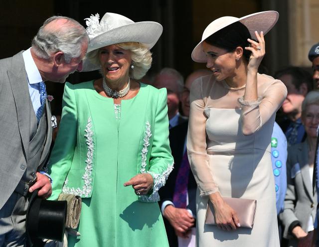 (FILES) Britain's Prince Charles, Prince of Wales (L) and his wife Britain's Camilla, Duchess of Cornwall (C), talk with Britain's Meghan, Duchess of Sussex, as her husband Britain's Prince Harry, Duke of Sussex (unseen), speaks during the Prince of Wales's 70th Birthday Garden Party at Buckingham Palace in London on May 22, 2018. Prince Harry and his wife Meghan, who cut ties with the British royal family in 2020, are moving back to the United Kingdom, British press reported on August 19, 2026. In a surprise move, the youngest son of King Charles III and Meghan, "plan to leave the United States by the end of the month to settle in a private, non-royal residence, which is said to be located outside London," The Telegraph said. (Photo by Dominic Lipinski / POOL / AFP)