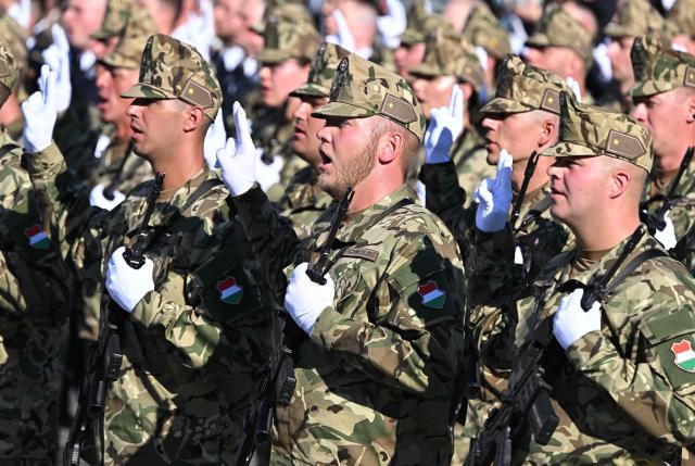 Hungarian army's newly-recruited officers march during a ceremony marking the country's national day attended by guests and ambassadors accredited to Hungary on August 20, 2026, in Budapest. Hungary marks the 1,026th anniversary of the foundation of the Hungarian state, established by the first king of Hungary, Stephen I.  Hungarian President Andras Baka, who took office yesterday, makes his first public appearance since then. (Photo by Attila KISBENEDEK / AFP)