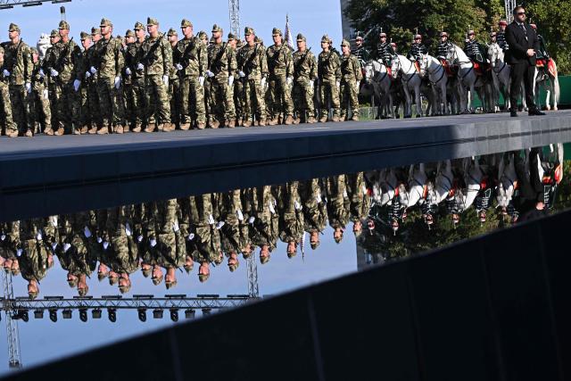 Hungarian army's newly-recruited officers are reflected in the water during a ceremony marking the country's national day attended by guests and ambassadors accredited to Hungary on August 20, 2026, in Budapest. Hungary marks the 1,026th anniversary of the foundation of the Hungarian state, established by the first king of Hungary, Stephen I.  Hungarian President Andras Baka, who took office yesterday, makes his first public appearance since then. (Photo by Attila KISBENEDEK / AFP)