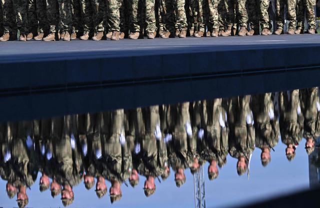 Hungarian army's newly-recruited officers are reflected in the water during a ceremony marking the country's national day attended by guests and ambassadors accredited to Hungary on August 20, 2026, in Budapest. Hungary marks the 1,026th anniversary of the foundation of the Hungarian state, established by the first king of Hungary, Stephen I.  Hungarian President Andras Baka, who took office yesterday, makes his first public appearance since then. (Photo by Attila KISBENEDEK / AFP)