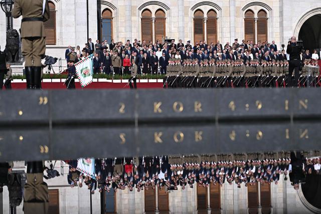 Soldiers march in front of Hungarian dignitaries, ambassadors and other guests during a ceremony marking the country's national day attended by guests and ambassadors accredited to Hungary on August 20, 2026, in Budapest. Hungary marks the 1,026th anniversary of the foundation of the Hungarian state, established by the first king of Hungary, Stephen I.  Hungarian President Andras Baka, who took office yesterday, makes his first public appearance since then. (Photo by Attila KISBENEDEK / AFP)