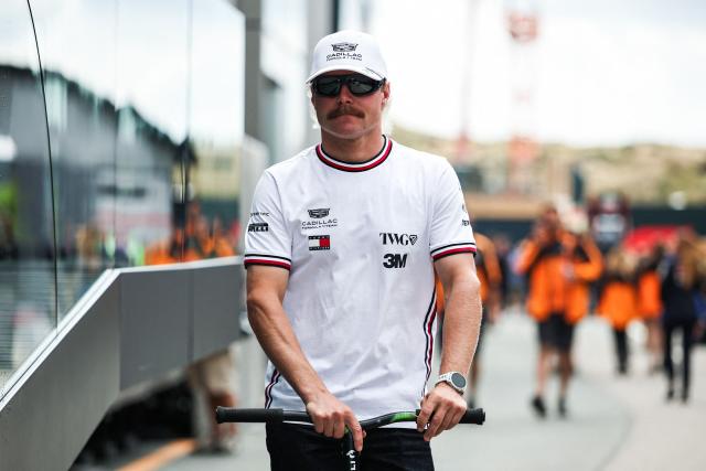 Cadillac's Finnish driver Valtteri Bottas drives a scooter in the paddock ahead of the Formula One Dutch Grand Prix at The Circuit Zandvoort, western Netherlands, on August 20, 2026. (Photo by SIMON WOHLFAHRT / AFP)