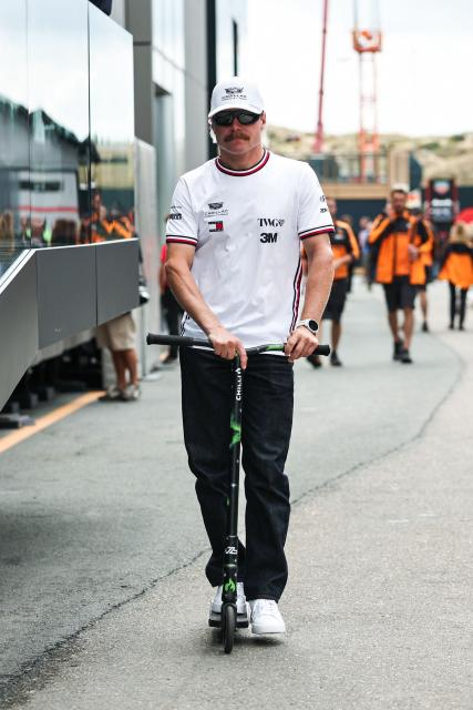 Cadillac's Finnish driver Valtteri Bottas drives a scooter in the paddock ahead of the Formula One Dutch Grand Prix at The Circuit Zandvoort, western Netherlands, on August 20, 2026. (Photo by SIMON WOHLFAHRT / AFP)