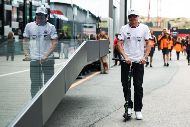 Cadillac's Finnish driver Valtteri Bottas drives a scooter in the paddock ahead of the Formula One Dutch Grand Prix at The Circuit Zandvoort, western Netherlands, on August 20, 2026. (Photo by SIMON WOHLFAHRT / AFP)