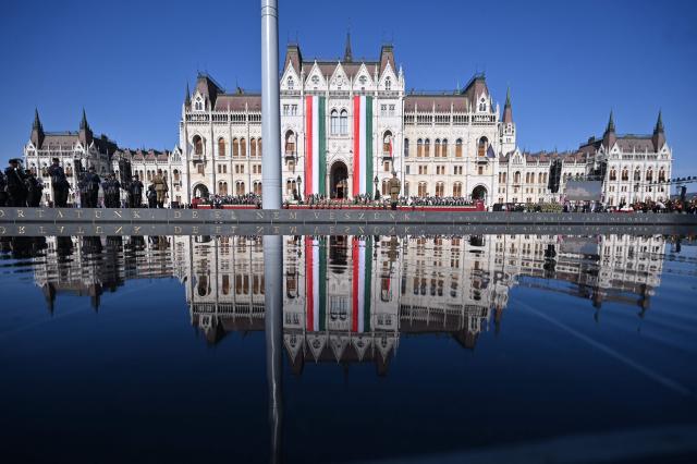 The parliament building is reflected in the water during a ceremony marking the country's national day attended by guests and ambassadors accredited to Hungary on August 20, 2026, in Budapest. Hungary marks the 1,026th anniversary of the foundation of the Hungarian state, established by the first king of Hungary, Stephen I.  Hungarian President Andras Baka, who took office yesterday, makes his first public appearance since then. (Photo by Attila KISBENEDEK / AFP)