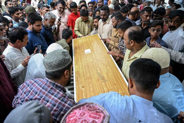 Relatives and residents carry the coffin of Muhammad Akram, a vessel's crew member who got killed in an attack by the Houthi rebels in the Red Sea, during a funeral ceremony in Karachi on August 20, 2026. (Photo by Rizwan TABASSUM / AFP)