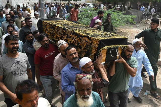 Relatives and residents carry the coffin of Muhammad Akram, a vessel's crew member who got killed in an attack by the Houthi rebels in the Red Sea, during a funeral ceremony in Karachi on August 20, 2026. (Photo by Rizwan TABASSUM / AFP)