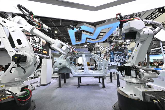 Industrial robots produced by Siasun or Xinsong are pictured during the 2026 World Robot Conference in Beijing on August 20, 2026. (Photo by ADEK BERRY / AFP)