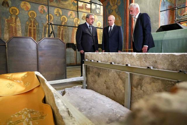 In this pool photograph distributed by the Russian state agency Sputnik, Russian President Vladimir Putin (C) visiting the reliquary containing the holy relics of the warrior prince Dmitry Donskoy in the Archangel Cathedral of the Moscow Kremlin in Moscow on August 20, 2026. (Photo by Viacheslav PROKOFIEV / POOL / AFP)