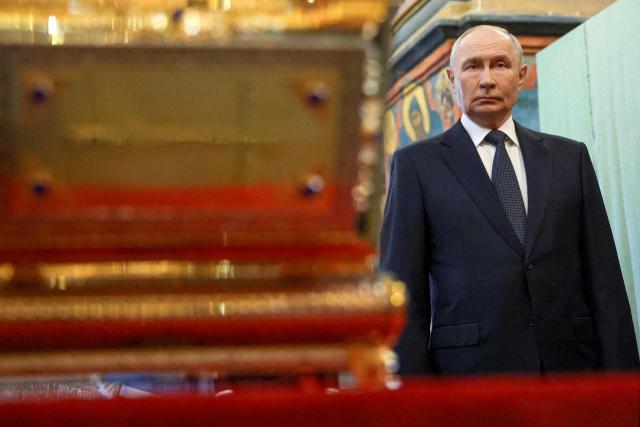 In this pool photograph distributed by the Russian state agency Sputnik, Russian President Vladimir Putin stands at the reliquary containing the holy relics of the warrior prince Dmitry Donskoy in the Archangel Cathedral of the Moscow Kremlin in Moscow on August 20, 2026. (Photo by Viacheslav PROKOFIEV / POOL / AFP)