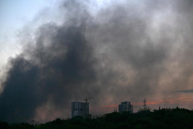 This photograph shows smoke rising at sunset following a drone strike in Kyiv, on August 20, 2026, amid the Russian invasion of Ukraine. (Photo by Sergei SUPINSKY / AFP)