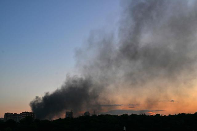 This photograph shows smoke rising at sunset following a drone strike in Kyiv, on August 20, 2026, amid the Russian invasion of Ukraine. (Photo by Sergei SUPINSKY / AFP)