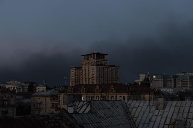 This photograph shows smoke rising over the buildings following a Russian air attack, in downtown Kyiv on August 20, 2026, amid the Russian invasion of Ukraine. (Photo by Roman PILIPEY / AFP)