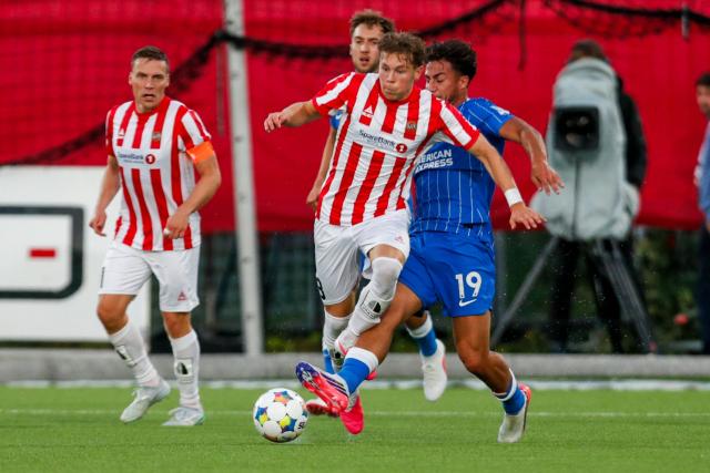 Brighton's Greek forward Charalampos Kostoulas (R) and Tromsø's Norwegian midfielder Jesper Grundt vie for the ball during the UEFA Conference League play-offs first leg football match between Tromso and 
Brighton and Hove Albion at Romssa Arena in Tromso, Norway, on August 20, 2026. (Photo by Rune Stoltz Bertinussen / NTB / AFP) / Norway OUT
