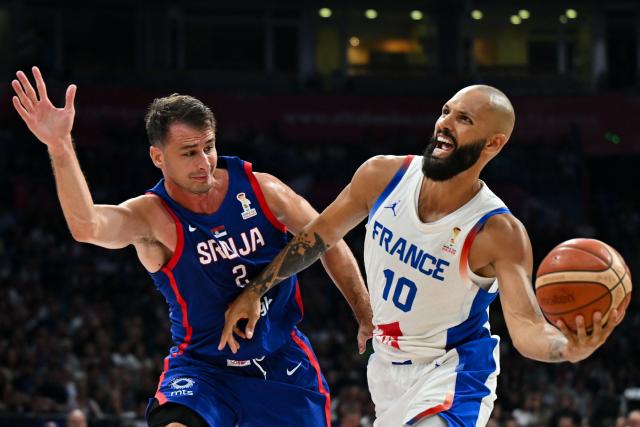 France's #10 Evan Fournier (R) dribbles against Serbia's #02 Nemanja Dangubic (L) during the friendly basketball match between Serbia and France, at the Belgrade Arena, in Belgrade, on August 20, 2026. (Photo by Andrej ISAKOVIC / AFP)