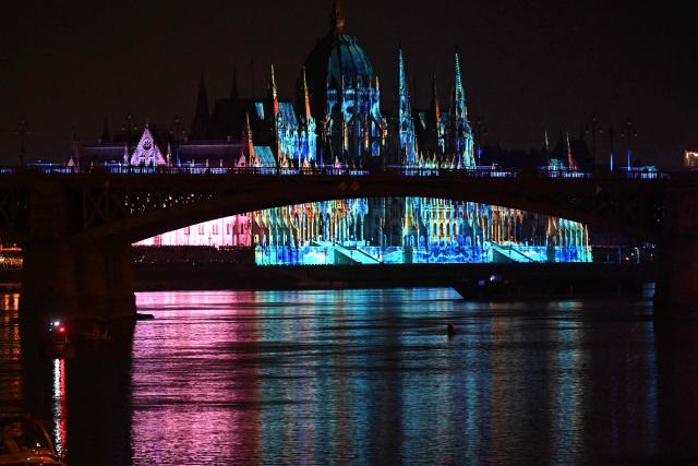 The Hungarian Parliament building is illuminated as part of celebrations marking Hungary's National Day, in Budapest, on August 20, 2026. Hungary celebrated the 1,026th anniversary of the foundation of the Hungarian state, established by the first king of Hungary, Stephen I. (Photo by Attila KISBENEDEK / AFP)