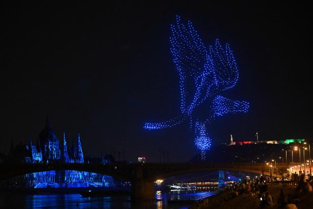 Drones create an image of a Turul bird in the sky over the Danube River in front of the Hungarian Parliament building as part of celebrations marking Hungary's National Day, in Budapest, on August 20, 2026. Hungary celebrated the 1,026th anniversary of the foundation of the Hungarian state, established by the first king of Hungary, Stephen I. (Photo by Attila KISBENEDEK / AFP)