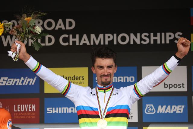 (FILES) Gold medallist  France's Julian Alaphilippe, wearing his World champion's rainbow jersey, celebrates on the podium after winning the men's elite cycling road race, 268,3km from Antwerp to Leuven, on the eighth day of the Flanders 2021 UCI Road World Championships, on September 26, 2021, in Leuven. French cyclist Julian Alaphilippe, a two-time world champion and winner of MilanSanremo, is set to retire at the age of 34, according to reports on August 20, 2026 evening, including in the daily newspaper L'Equipe. (Photo by Kenzo Tribouillard / AFP)