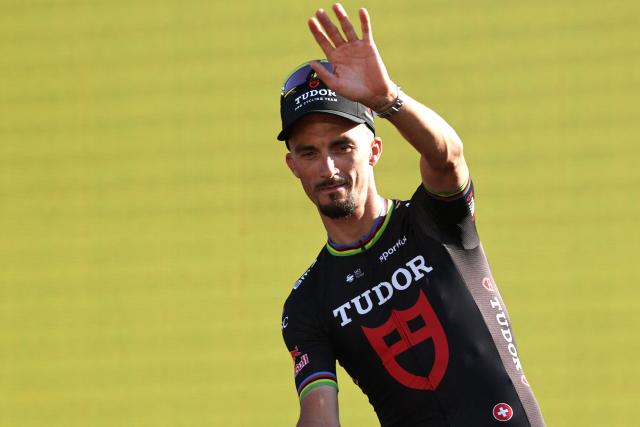 (FILES) Tudor Pro Cycling Team's French rider Julian Alaphilippe waves as he and his teammates attend the team presentation ceremony ahead of the 113th edition of the Tour de France cycling race, with the Sagrada Familia Basilica seen in the background, in Barcelona, northeastern Spain, on July 2, 2026. French cyclist Julian Alaphilippe, a two-time world champion and winner of MilanSanremo, is set to retire at the age of 34, according to reports on August 20, 2026 evening, including in the daily newspaper L'Equipe. (Photo by Anne-Christine POUJOULAT / AFP)