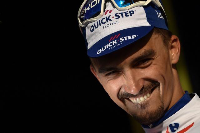 (FILES) France's Julian Alaphilippe celebrates on the podium after winning the tenth stage of the 105th edition of the Tour de France cycling race between Annecy and Le Grand-Bornand, French Alps, on July 17, 2018. French cyclist Julian Alaphilippe, a two-time world champion and winner of Milan–Sanremo, is set to retire at the age of 34, according to reports on August 20, 2026 evening, including in the daily newspaper L'Equipe. (Photo by Marco BERTORELLO / AFP)