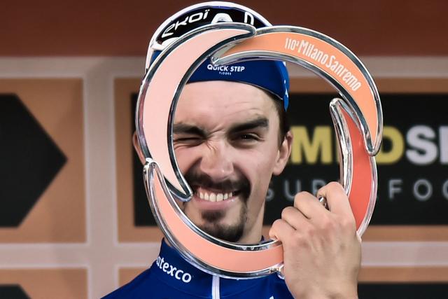 (FILES) France's Julian Alaphilippe poses with his trophy as he celebrates on the podium after winning the one-day classic cycling race Milan - San Remo on March 23, 2019. French cyclist Julian Alaphilippe, a two-time world champion and winner of Milan–Sanremo, is set to retire at the age of 34, according to reports on August 20, 2026 evening, including in the daily newspaper L'Equipe. (Photo by Marco BERTORELLO / AFP)