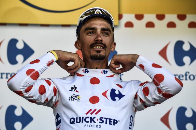 (FILES) France's Julian Alaphilippe puts on the best climber's polka dot jersey on the podium after winning the 16th stage of the 105th edition of the Tour de France cycling race, between Carcassonne and Bagneres-de-Luchon, southwestern France, on July 24, 2018. French cyclist Julian Alaphilippe, a two-time world champion and winner of Milan–Sanremo, is set to retire at the age of 34, according to reports on August 20, 2026 evening, including in the daily newspaper L'Equipe. (Photo by Jeff PACHOUD / AFP)