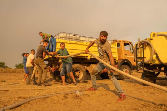 Local residents battle a forest wildfire in Deliblatska Pescara (Deliblato Sands), near the village of Grebenac, some 70 kilometres northeast of Belgrade on August 20, 2026. Firefighters were battling wildfires across the Balkans as days of high temperatures and drought conditions continue to drive blazes in several countries, including Serbia. Scientists have long warned that climate change caused by human use of fossil fuels will make periods of drought more intense and longer-lasting, creating the ideal conditions for wildfires. (Photo by Uros Arsic / AFP)