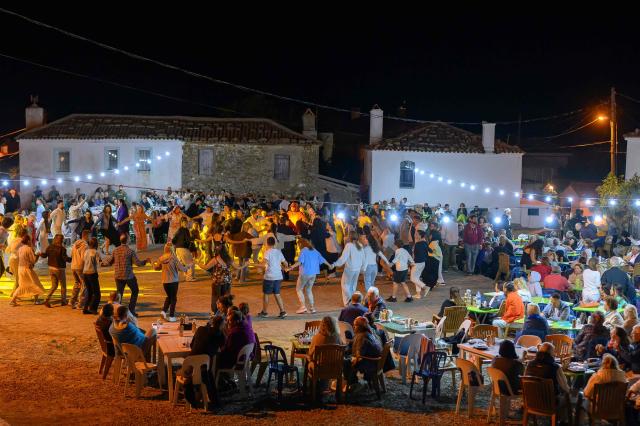 People are perform traditional Greek dance near Tepekoy Square during the Feast of the Dormition of the Virgin Mary on Gokceada (Imroz) Island, Çanakkale Province of Turkey, on August 16, 2026. Hundreds of Greeks return from Athens and around the world to Imbros each August 15 to celebrate the Virgin Mary. Like Istanbul and nearby Tenedos, the island was exempt from the 1923 population exchange between Greece and Turkey, which displaced more than 1.5 million people. (Photo by Yasin AKGUL / AFP)