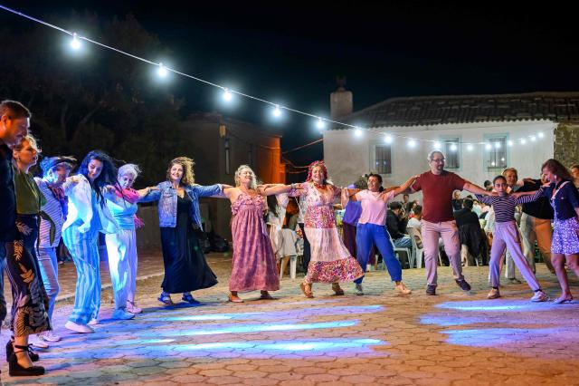 People are perform traditional Greek dance near Tepekoy Square during the Feast of the Dormition of the Virgin Mary on Gokceada (Imroz) Island, Çanakkale Province of Turkey, on August 15, 2026. Hundreds of Greeks return from Athens and around the world to Imbros each August 15 to celebrate the Virgin Mary. Like Istanbul and nearby Tenedos, the island was exempt from the 1923 population exchange between Greece and Turkey, which displaced more than 1.5 million people. (Photo by Yasin AKGUL / AFP)