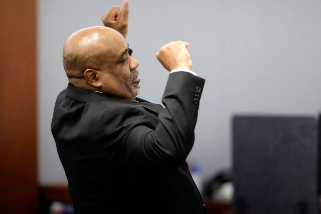 Duane Davis stretches after a day in court during his murder trial, related to the 1996 killing of rapper Tupac Shakur, at Clark County District Court at the Regional Justice Center in Las Vegas, Nevada, on August 20, 2026. The trial of the former gang leader accused of orchestrating the murder of rapper Tupac Shakur began on August 10, 30 years after one of America's most high-profile unresolved killings. The proceedings, expected to last a month, will likely not make clear who fired the shots that killed the California hip-hop legend on the night of September 7, 1996, while he was in Las Vegas to see a Mike Tyson boxing match. (Photo by Steve Marcus / POOL / AFP)