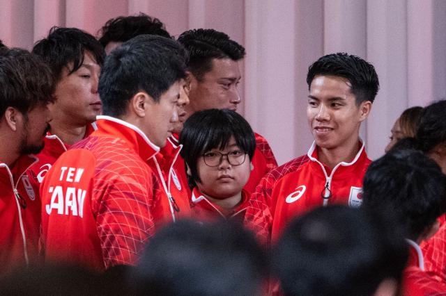11-year-old Yuki Kurihara (C), looks on past other athletes as he waits for a team Japan photo after a send off ceremony for the 2026 Asian Games Japan team at the Grand Prince Hotel Shin Takanawa in Tokyo on August 19, 2026. Yuki Kurihara will become Japan's youngest athlete in Asian Games history next month and the 11-year-old eSports whizz-kid wants to be the competition's youngest ever medallist too. (Photo by ANDREW CABALLERO-REYNOLDS / AFP)