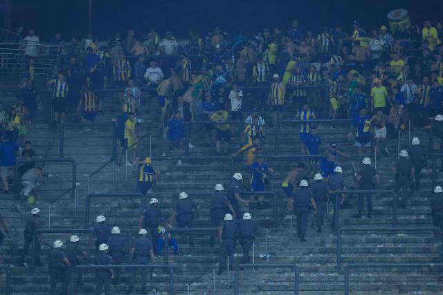 Rosario Central's fans Rosario Central’s fans clash with police at the end of the Copa Libertadores round of 16 football match between Brazil's Corinthians and Argentina's Rosario Central at the Neo Quimica Arena stadium in Sao Paulo, Brazil, on August 20, 2026. (Photo by Miguel SCHINCARIOL / AFP)
