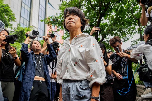 Elizabeth Tang Yin-ngor (C), wife of former union leader Lee Cheuk-yan, leaves the West Kowloon Magistrates' Courts after the verdict in the national security trial of two pro-democracy Tiananmen activists, in Hong Kong on August 21, 2026. A Hong Kong court found two pro-democracy activists who organised annual vigils to mark China's deadly Tiananmen crackdown guilty of "incitement to subversion" on August 21. (Photo by Leung Man Hei / AFP)