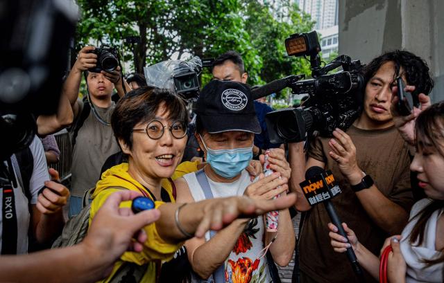 Lau Ka-yee (L), former Hong Kong Alliance standing committee member, and Medina Chow Lau Wah-chun (C), Chow Hang-tung's mother, leave the West Kowloon Magistrates' Courts after the verdict in the national security trial of two pro-democracy Tiananmen activists, in Hong Kong on August 21, 2026. A Hong Kong court found two pro-democracy activists who organised annual vigils to mark China's deadly Tiananmen crackdown guilty of "incitement to subversion" on August 21. (Photo by Leung Man Hei / AFP)
