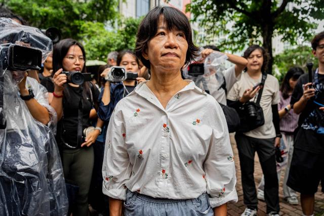 Elizabeth Tang Yin-ngor (C), wife of former union leader Lee Cheuk-yan, leaves the West Kowloon Magistrates' Courts after the verdict in the national security trial of two pro-democracy Tiananmen activists, in Hong Kong on August 21, 2026. A Hong Kong court found two pro-democracy activists who organised annual vigils to mark China's deadly Tiananmen crackdown guilty of "incitement to subversion" on August 21. (Photo by Leung Man Hei / AFP)