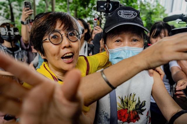 Lau Ka-yee (L), former Hong Kong Alliance standing committee member, and Medina Chow Lau Wah-chun (R), Chow Hang-tung's mother, leave the West Kowloon Magistrates' Courts after the verdict in the national security trial of two pro-democracy Tiananmen activists, in Hong Kong on August 21, 2026. A Hong Kong court found two pro-democracy activists who organised annual vigils to mark China's deadly Tiananmen crackdown guilty of "incitement to subversion" on August 21. (Photo by Leung Man Hei / AFP)