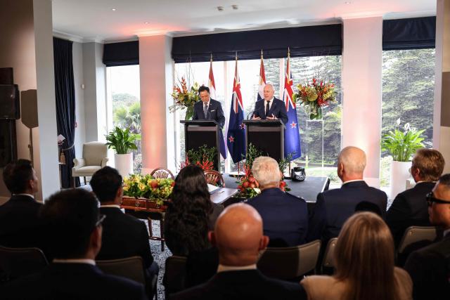 Thailand's Prime Minister Anutin Charnvirakul (L) and New Zealand's Prime Minister Christopher Luxon (R) speak to media during a document signing ceremony at the Government House in Auckland on August 21, 2026. (Photo by Michael Bradley / AFP)