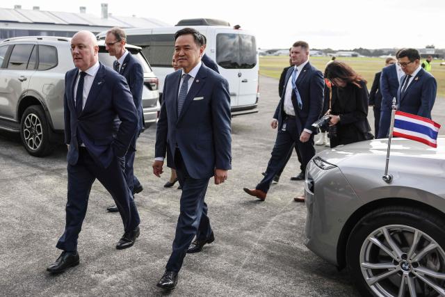 Thailand's Prime Minister Anutin Charnvirakul (C) and New Zealand's Prime Minister Christopher Luxon (L) arrive to visit the aircraft manufacturing company 'NZ Aero' in Auckland on August 21, 2026. (Photo by Michael Bradley / AFP)