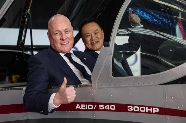 Thailand's Prime Minister Anutin Charnvirakul (R) and New Zealand's Prime Minister Christopher Luxon (L) pose in a CT/4E plane during a visit to aircraft manufacturing company 'NZ Aero' in Auckland on August 21, 2026. (Photo by Michael Bradley / AFP)